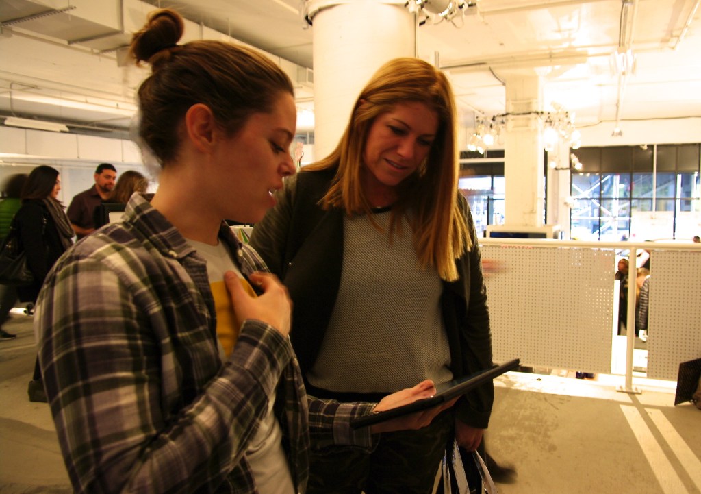 Kika Gilbert (Community Manager of Tinybop) left, demoing Homes app to Kim Kelleher (Publisher of Wired) right.